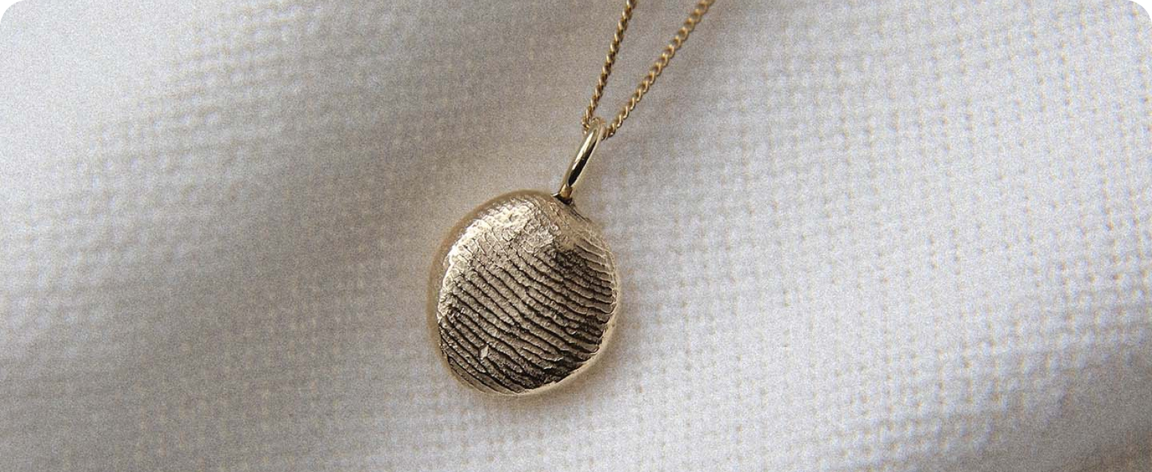 Heirloom impression pendant on a cloth background